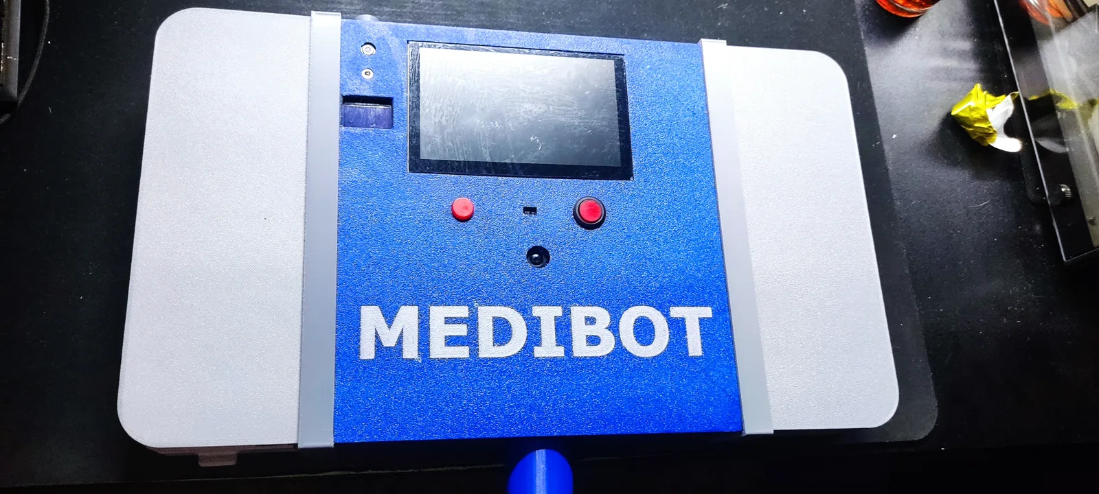 MEDIBOT: a blue and white 3D-printed enclosure with a screen and two buttons