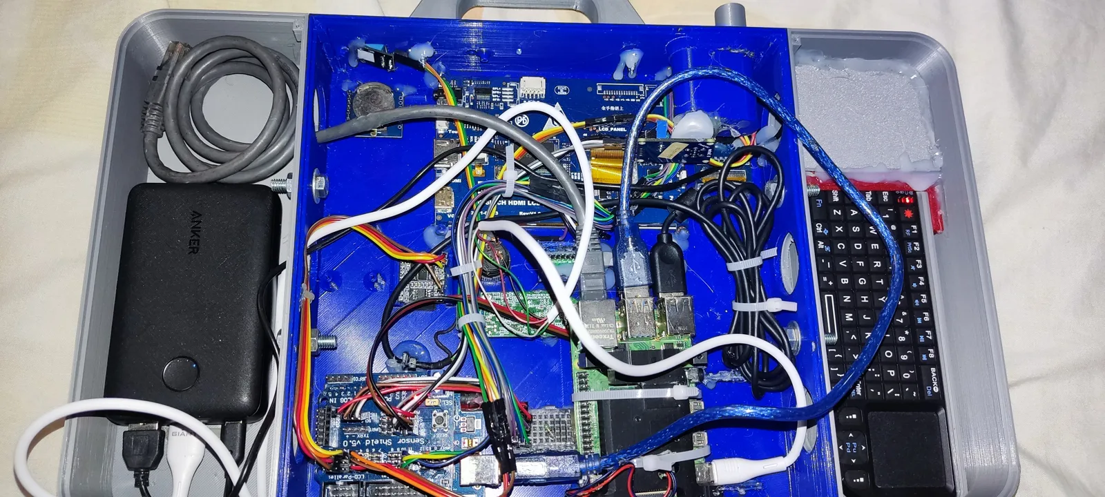 Inside the MEDIBOT case: Raspberry Pi 4, Arduino, sensor wiring, and power bank